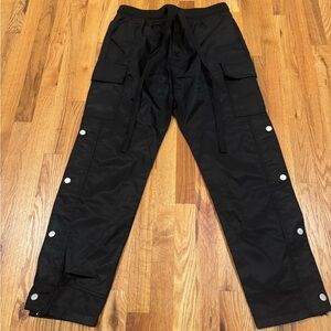 Black cargo pants with adjustable waist and ankle straps size 32 Snap Details